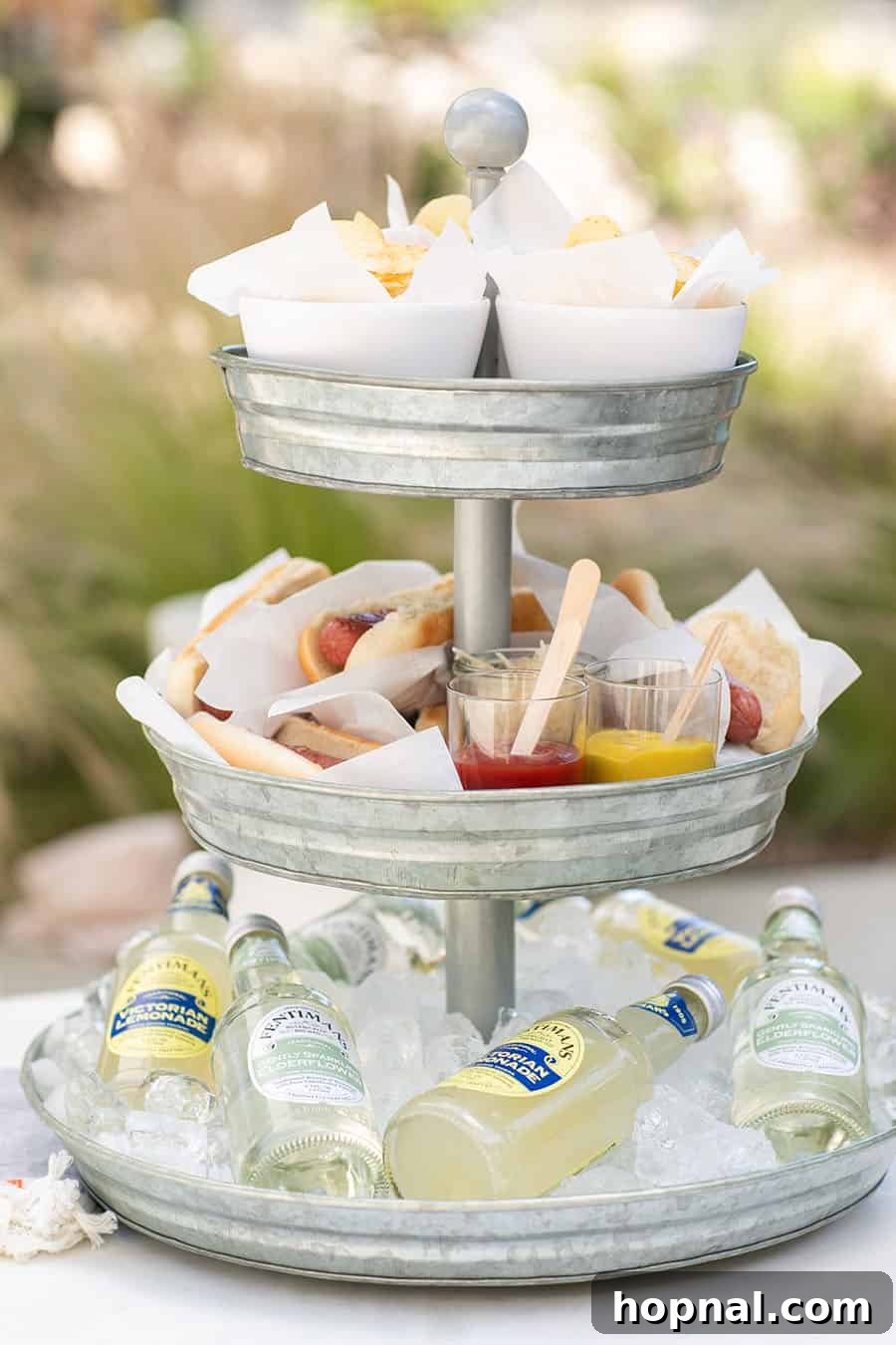 Elevate Your Decor: Tiered Galvanized Tray Ideas 2 A festive tiered galvanized tray holding potato chips, hot dogs, and sodas, perfectly arranged for a casual gathering.
