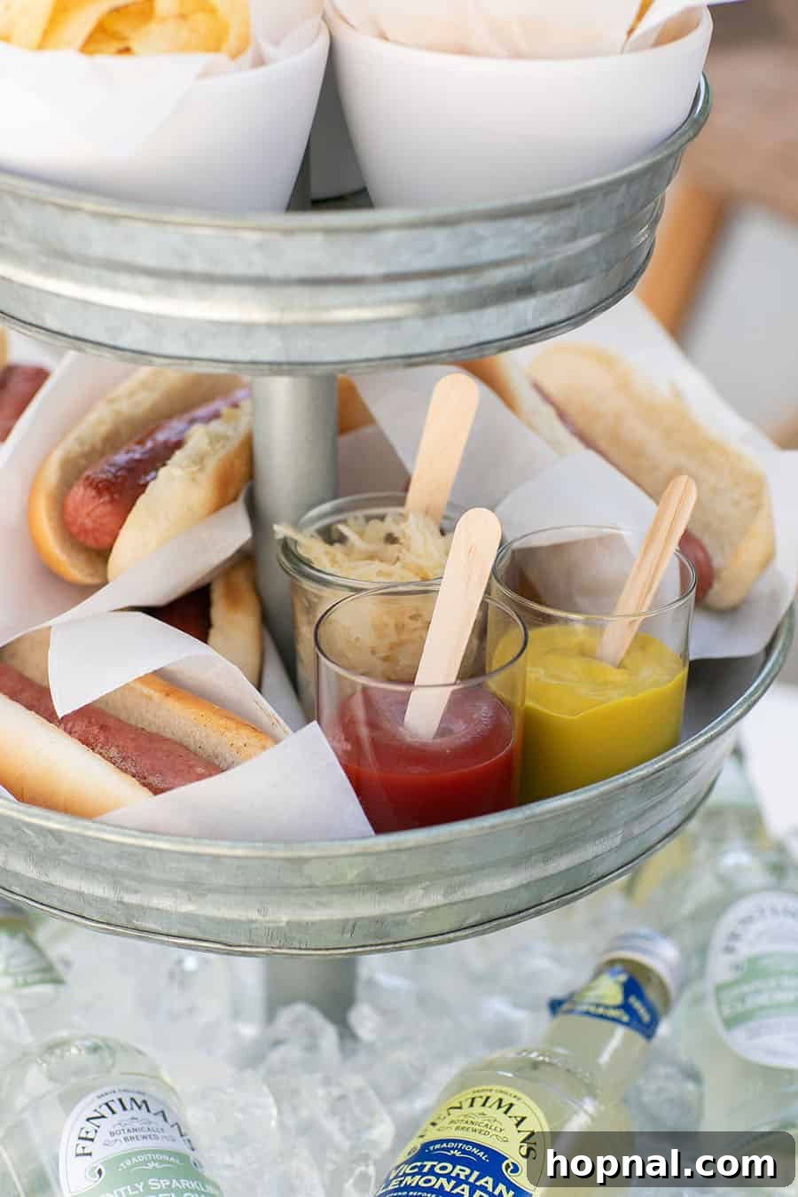 Elevate Your Decor: Tiered Galvanized Tray Ideas 3 Close-up of a tiered galvanized tray meticulously arranged with hot dogs, complete with small cups of mustard and ketchup for easy serving.