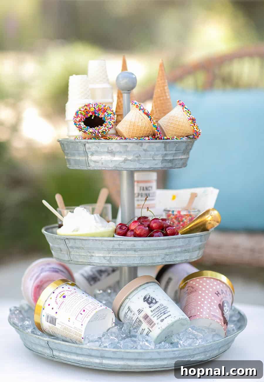 Elevate Your Decor: Tiered Galvanized Tray Ideas 5 A delightful tiered galvanized tray laden with ice cream cones, colorful sprinkles, various ice cream tubs, and fresh cherries, creating an inviting dessert bar.