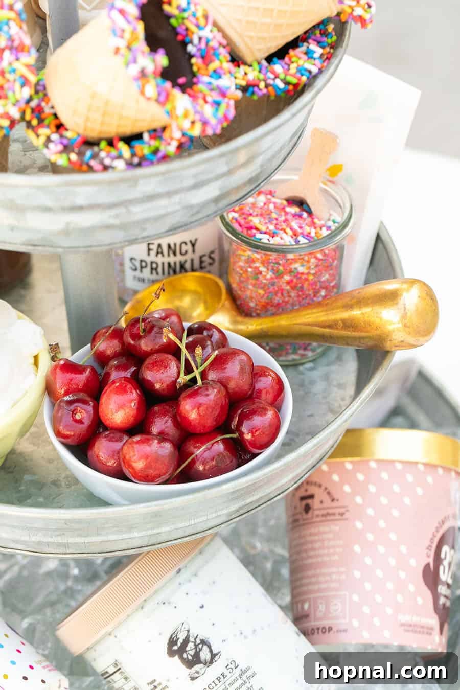 Elevate Your Decor: Tiered Galvanized Tray Ideas 6 A detailed shot of a tiered galvanized tray, highlighting fresh cherries in a white bowl and a stylish copper ice cream scooper, essential for any ice cream bar.