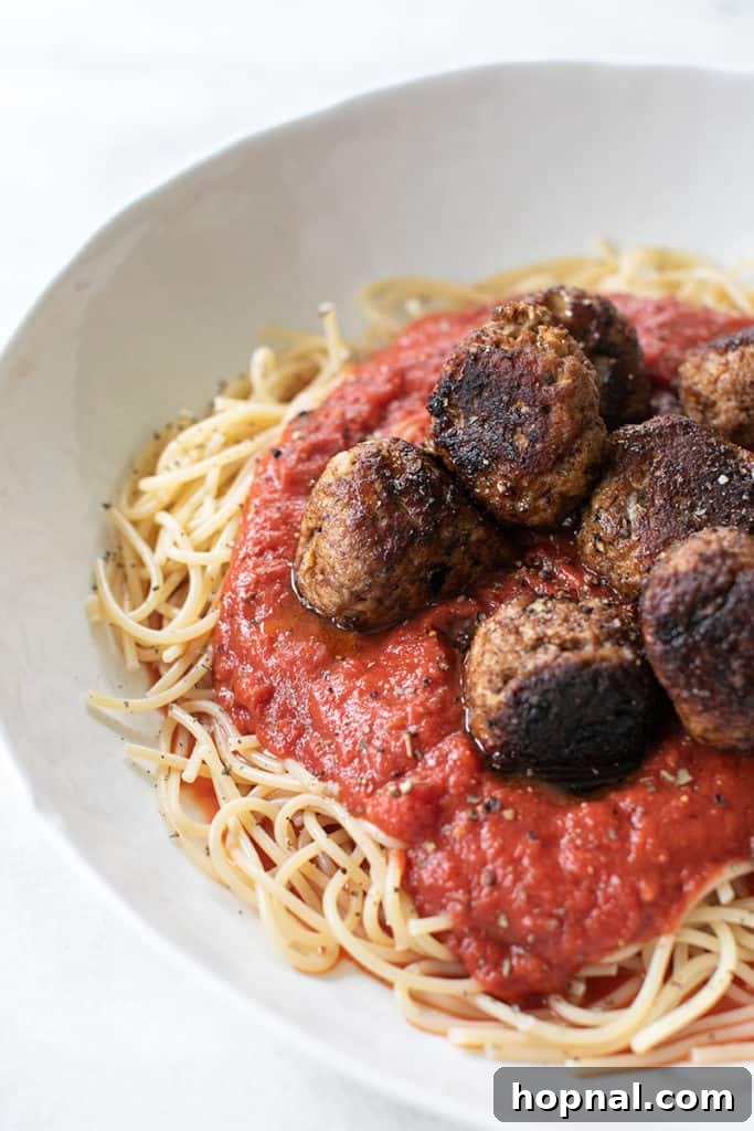 Savory Turkey Meatball Delights 10 Cooked turkey meatballs submerged in a rich red marinara sauce, ready to be served.