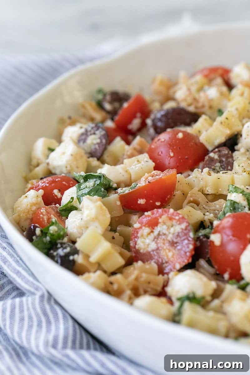 An overhead shot of a large bowl filled with Summer Pasta Salad, featuring a generous mix of ingredients.