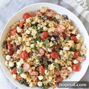 The best pasta salad recipe with cherry tomatoes, olive oil, cheese, olives, garlic and basil.