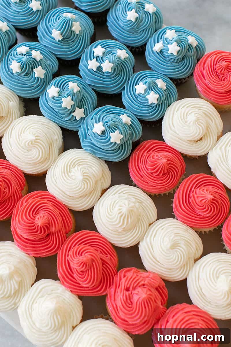 Flag Cupcake Cake with vibrant blue and red frosting and delicate white star sprinkles