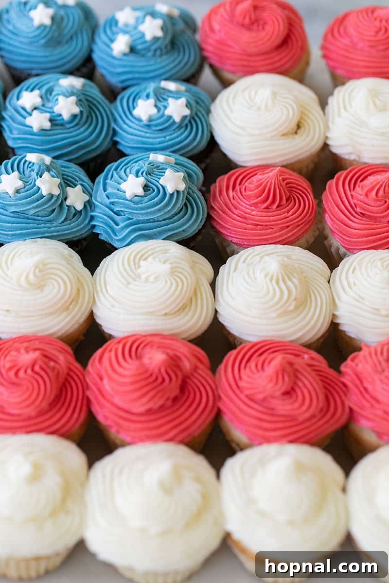 Partially assembled cupcake cake shaped like a flag with red, white, and blue cupcakes