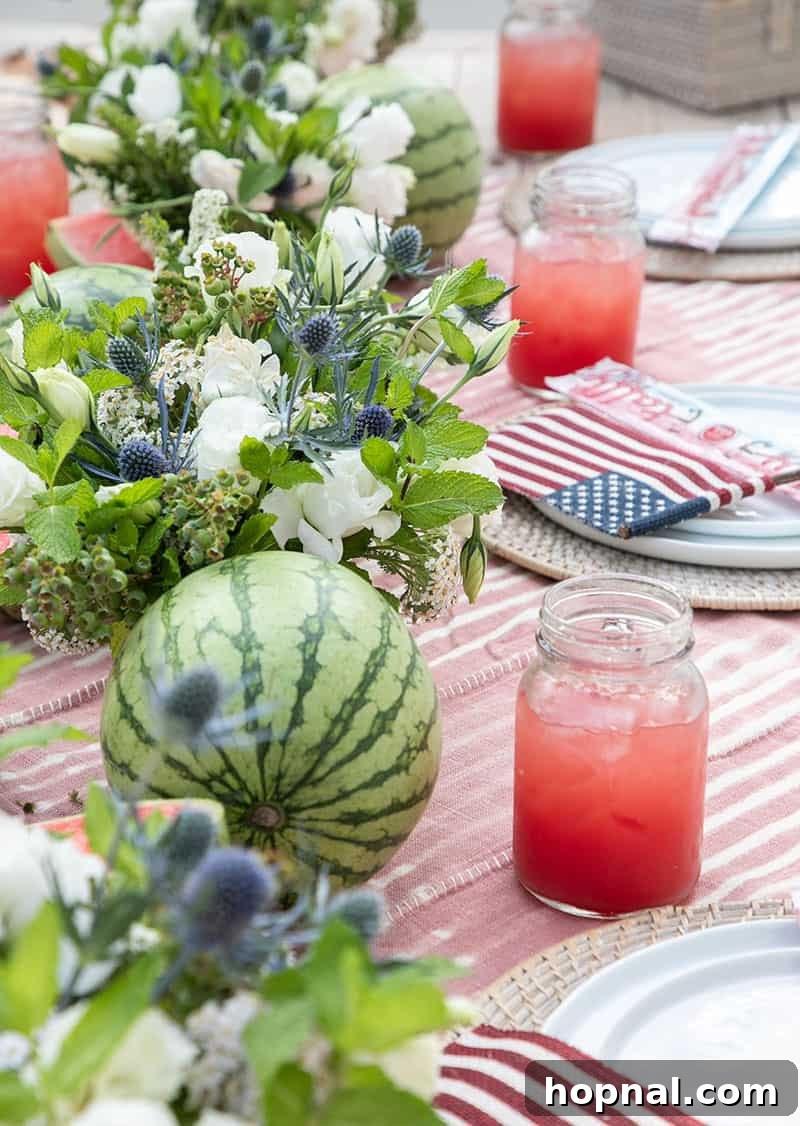 A refreshing watermelon, elegant floral arrangements, and a large jar brimming with fresh watermelon juice, creating a vibrant and hydrating display for an outdoor party.