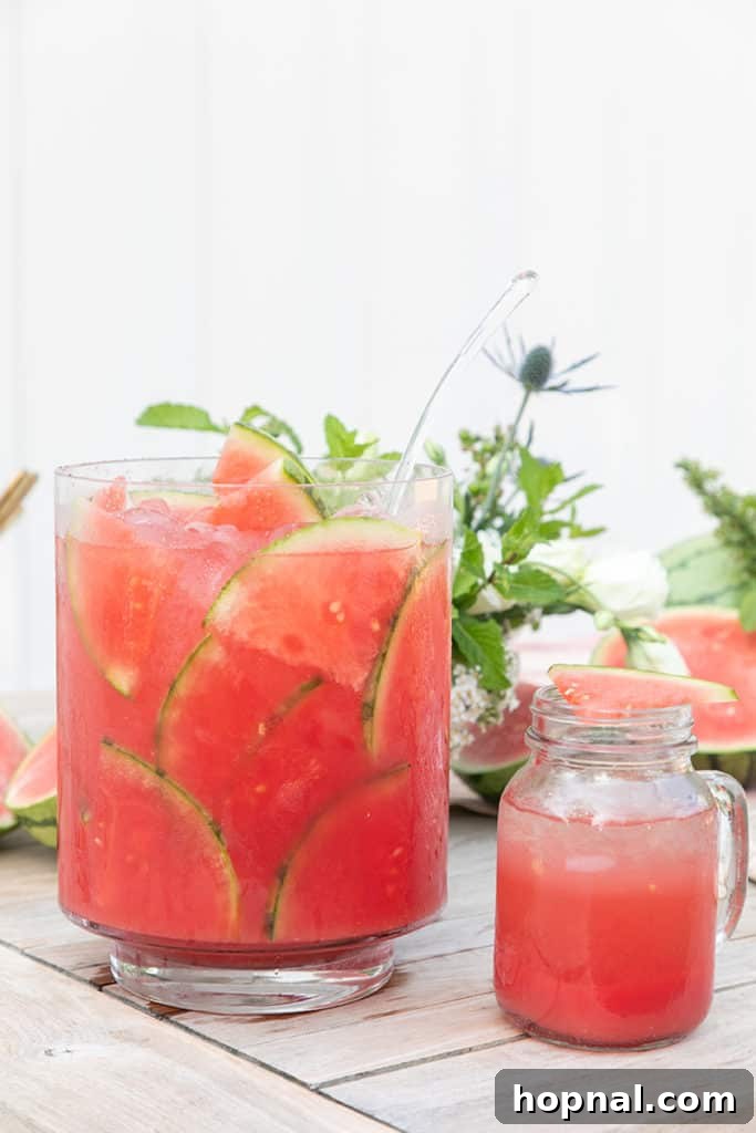 A vibrant watermelon punch, garnished with fresh fruit, perfect for a refreshing 4th of July celebration.