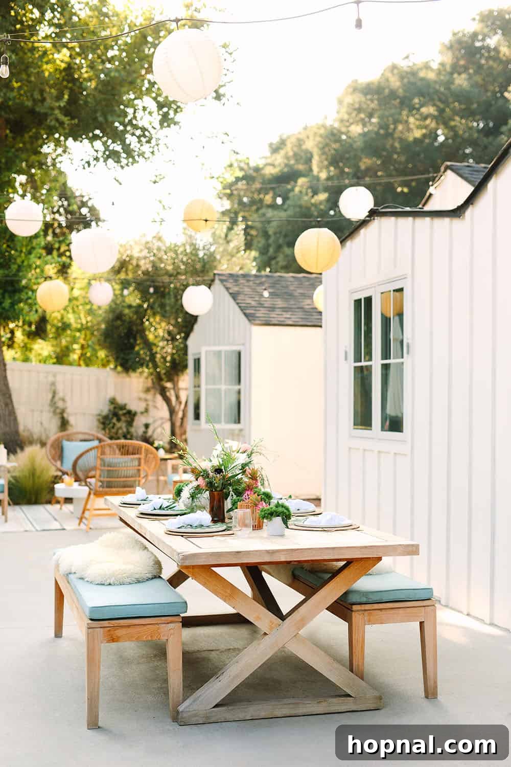 Vibrant outdoor table setup and exotic decorations for a tropical summer party, featuring lush foliage and colorful accents.
