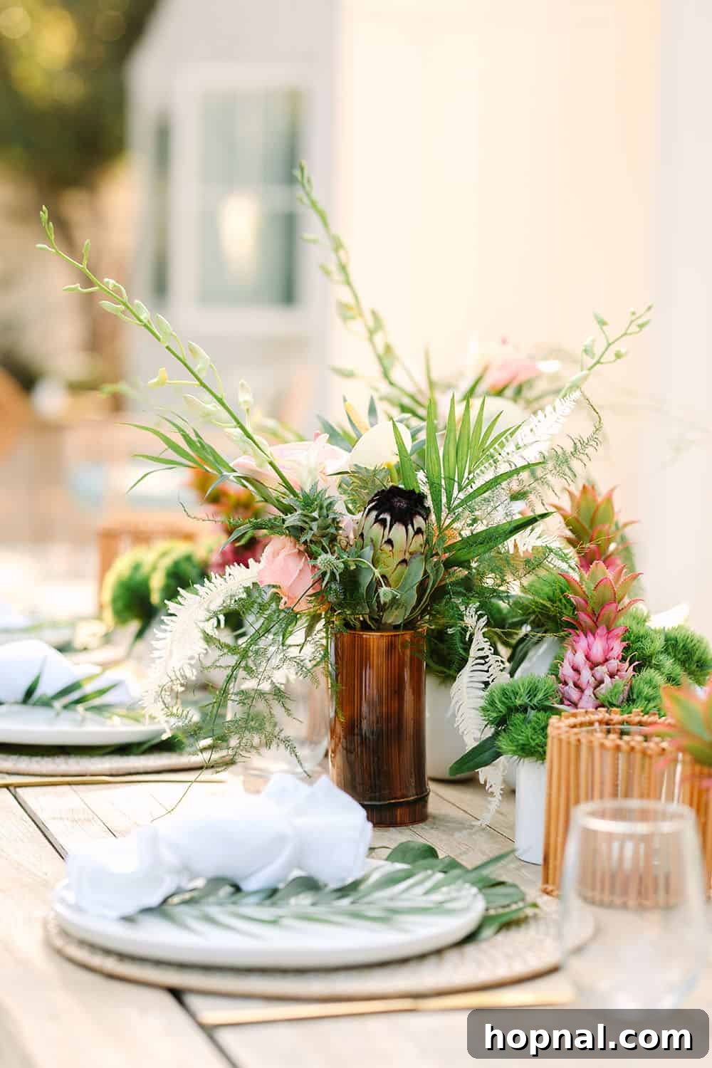 Stunning tropical flowers beautifully arranged in natural bamboo vases, serving as elegant centerpieces.