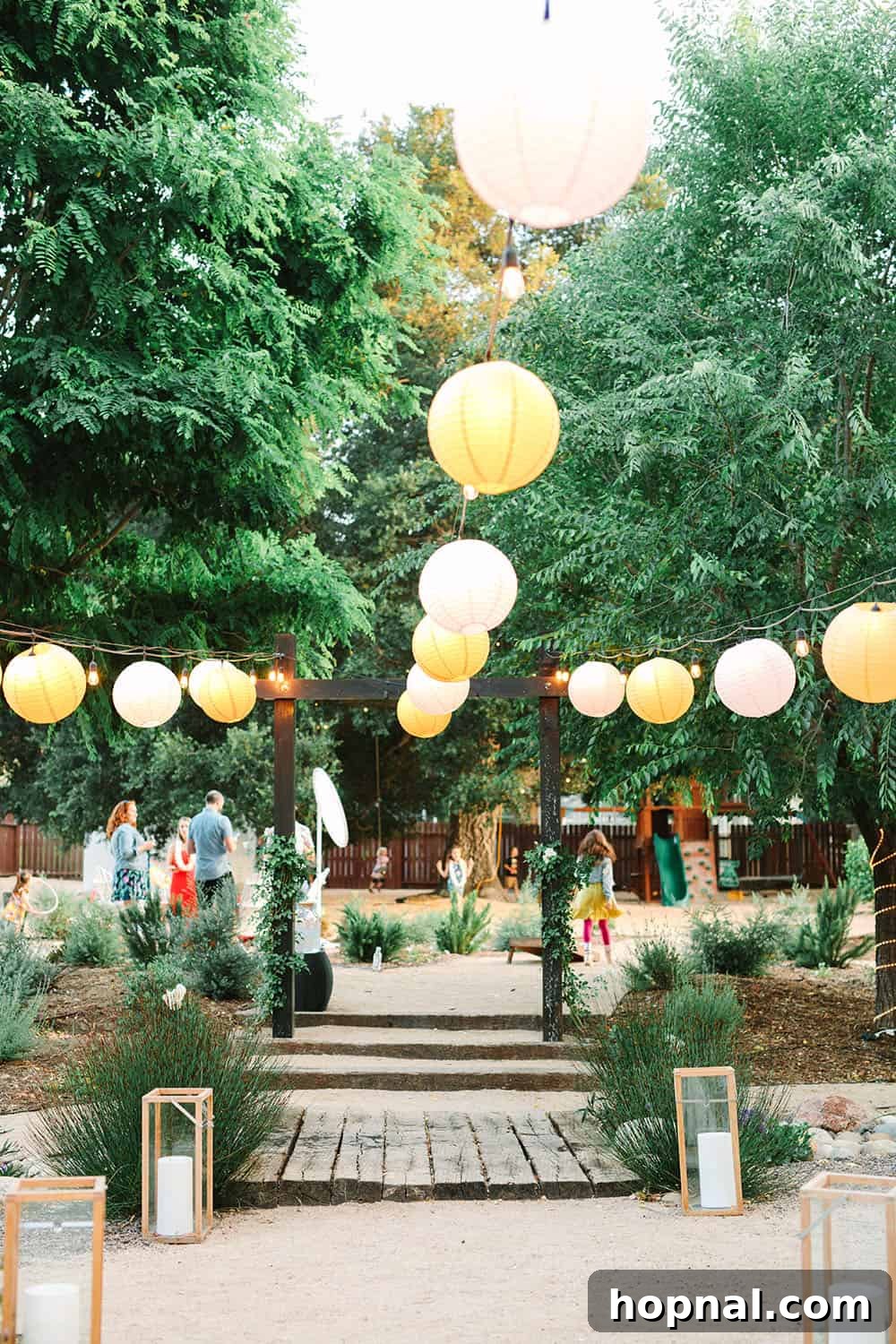 Magical paper lanterns hanging gracefully over a beautifully decorated backyard, perfect for a tropical evening party.