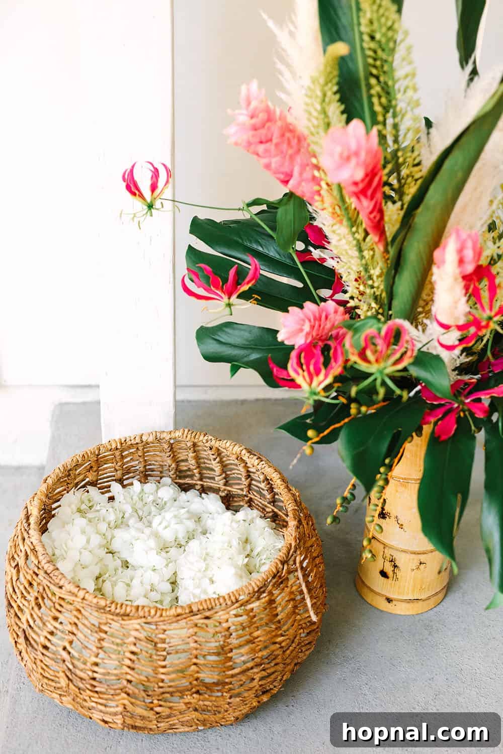 A collection of fresh leis and vibrant tropical flowers, ready to welcome guests to a themed party.