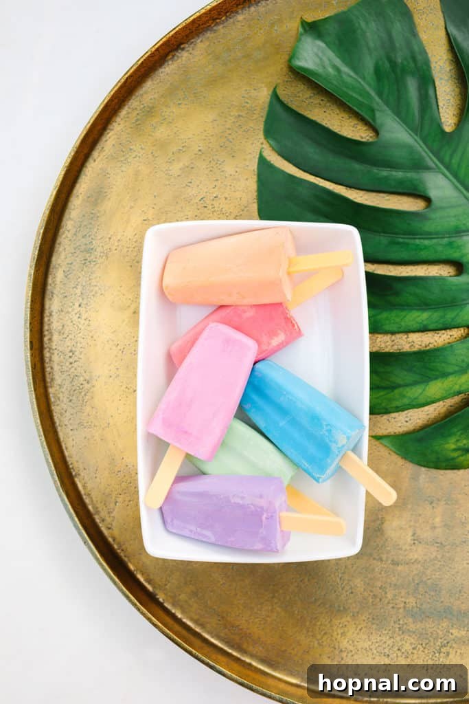 Popsicle-shaped sidewalk chalk in a white bowl, ready for creative fun at a children's activity station.