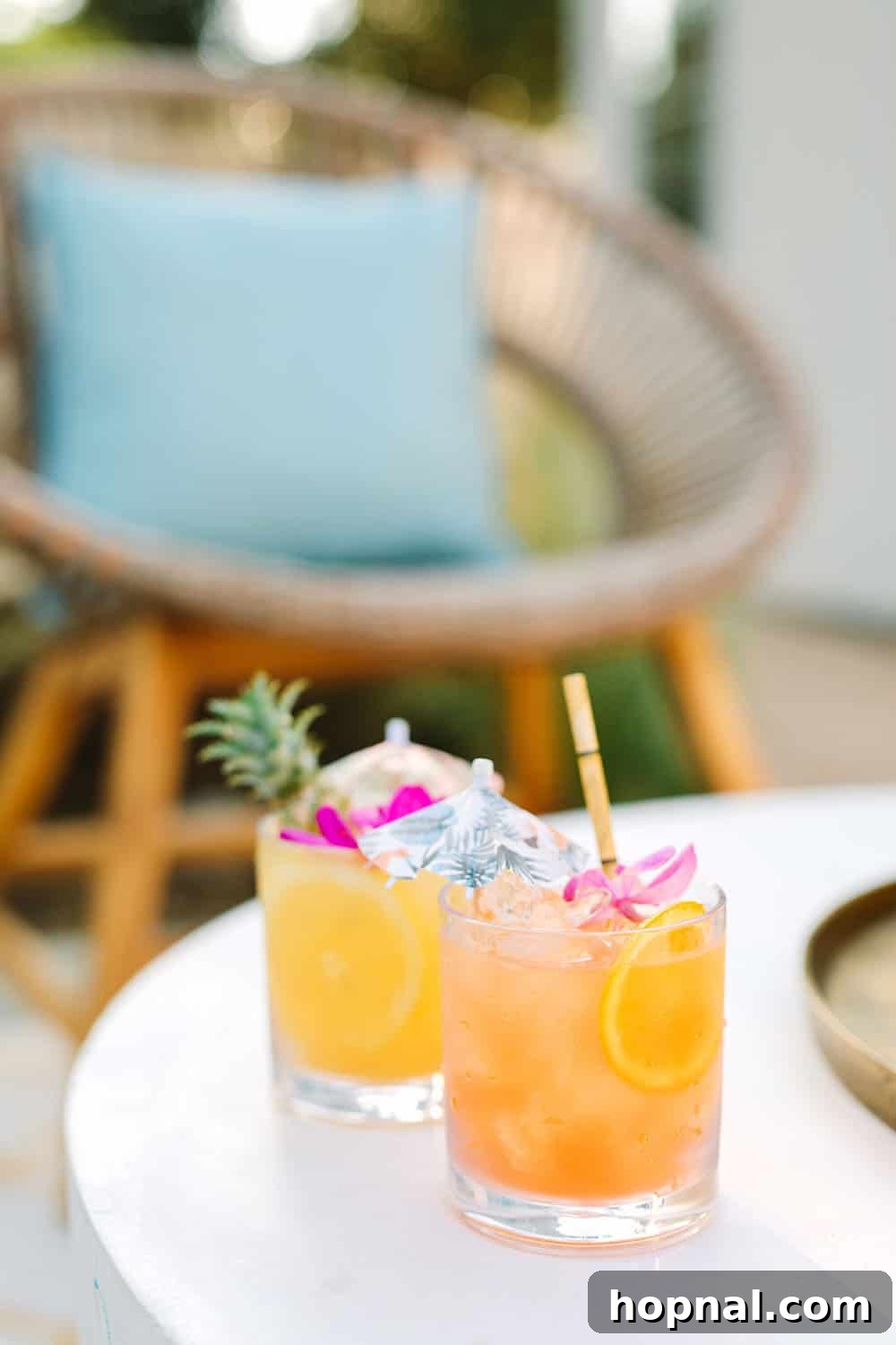 Refreshing tropical cocktails from Williams Sonoma, garnished with pineapple slices, perfect for a sunny outdoor party.