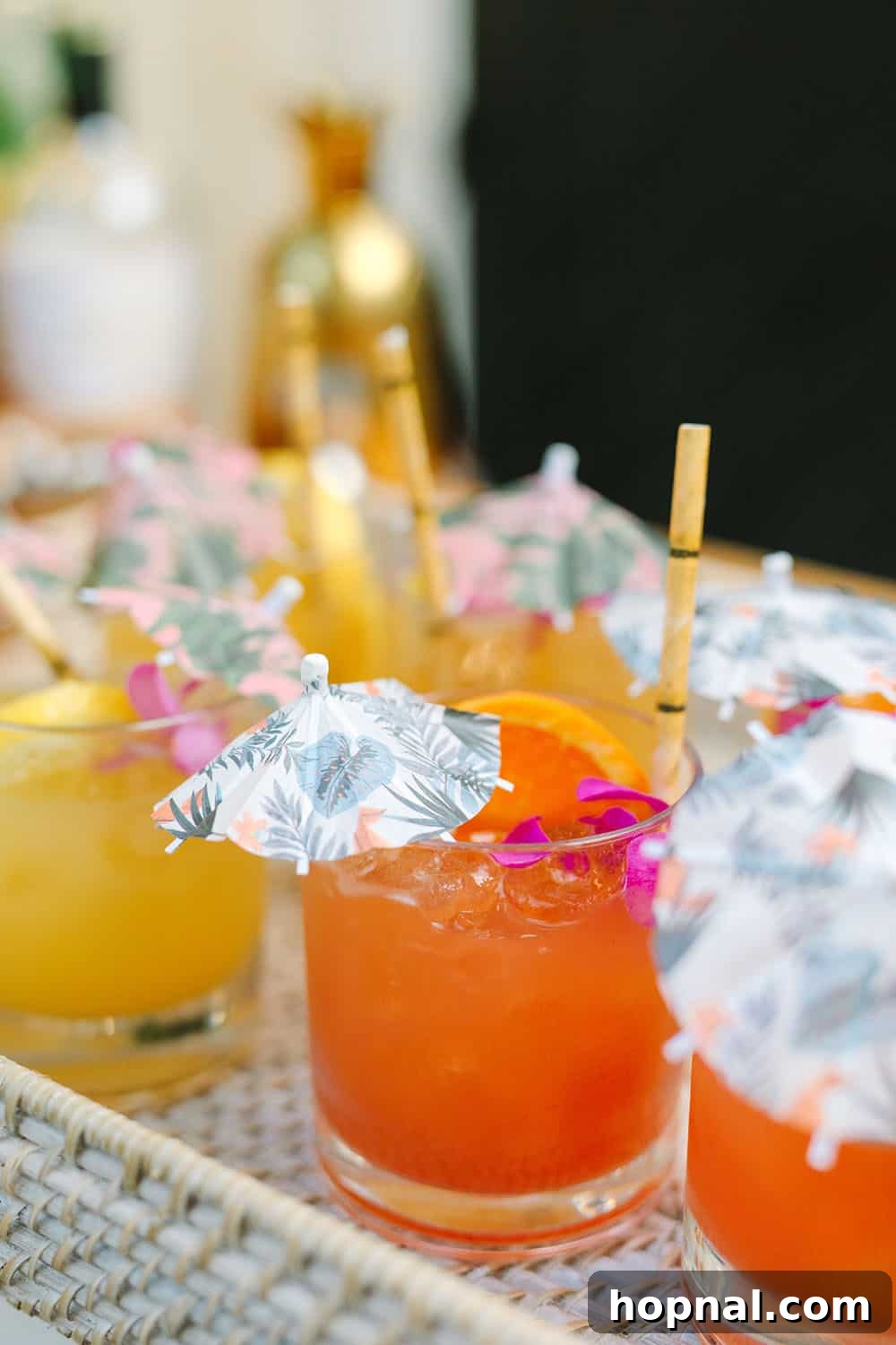 Exotic tropical cocktails adorned with playful umbrellas and sustainable bamboo straws, capturing the essence of a summer celebration.