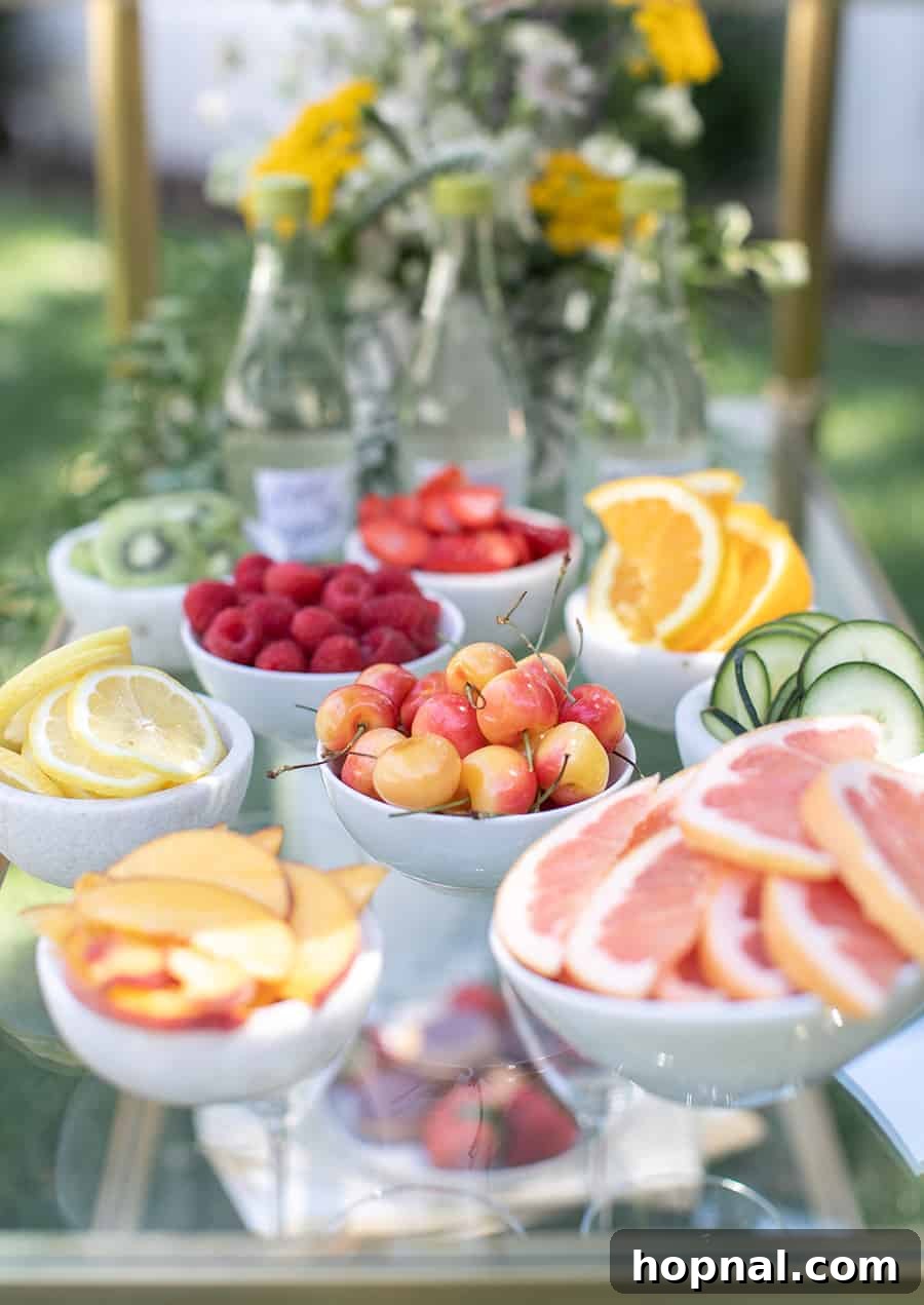 Craft Your Own Spritzer Bar 4 Small bowls filled with colorful cherries, apple slices, and grapefruit wedges on a gold bar cart, ready for spritzer garnishes.