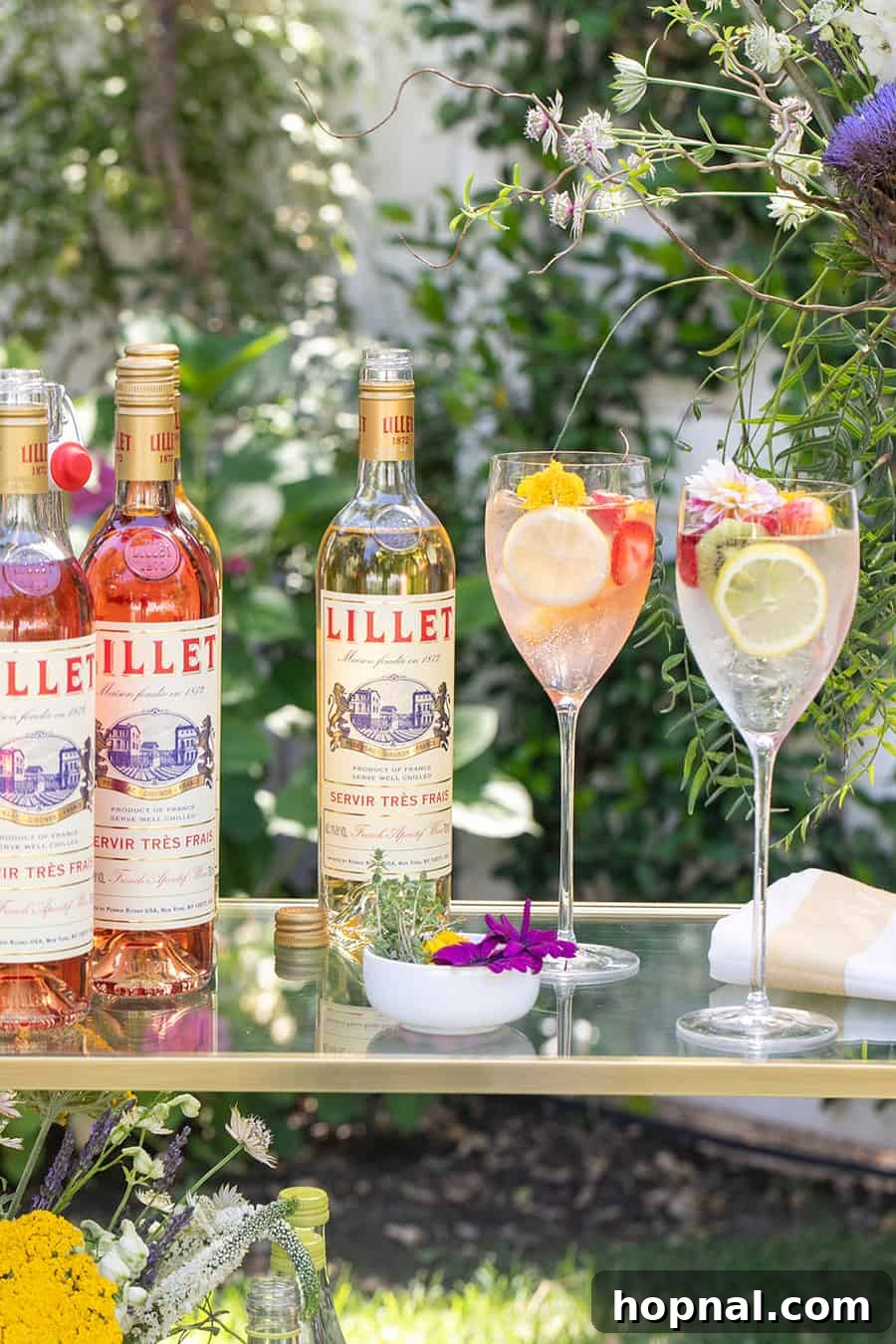 Craft Your Own Spritzer Bar 9 A bottle of Lillet displayed on a bar cart alongside elegant wine glasses, ready for guests to craft their spritzers.