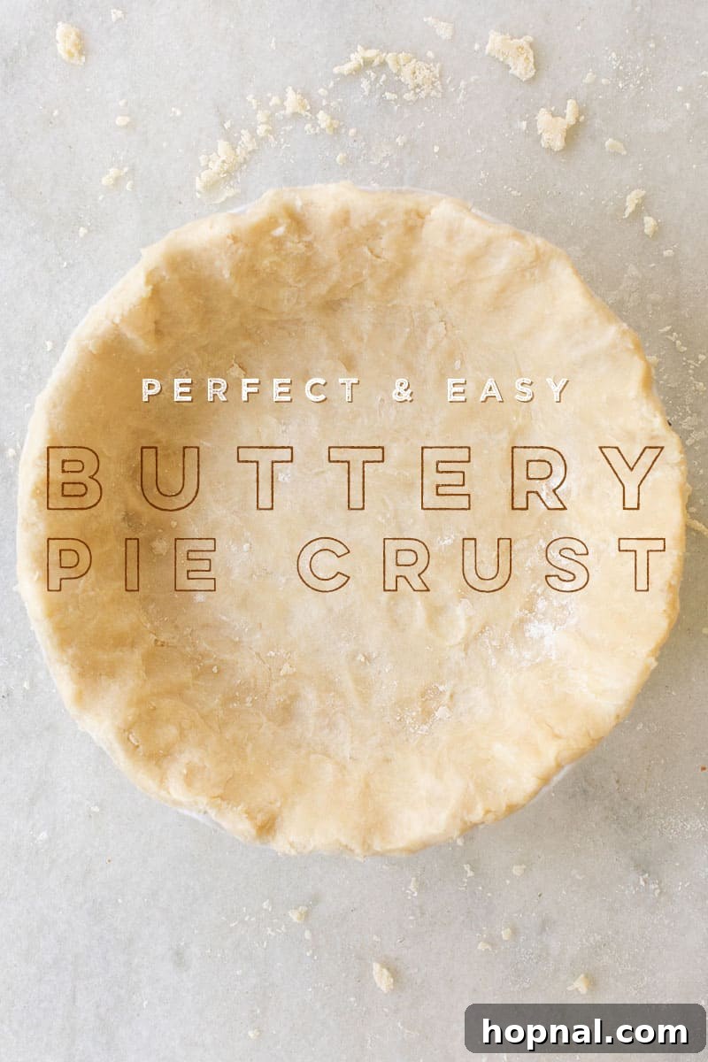 Close-up of a golden, flaky homemade buttery pie crust on a pristine marble table, ready for baking.