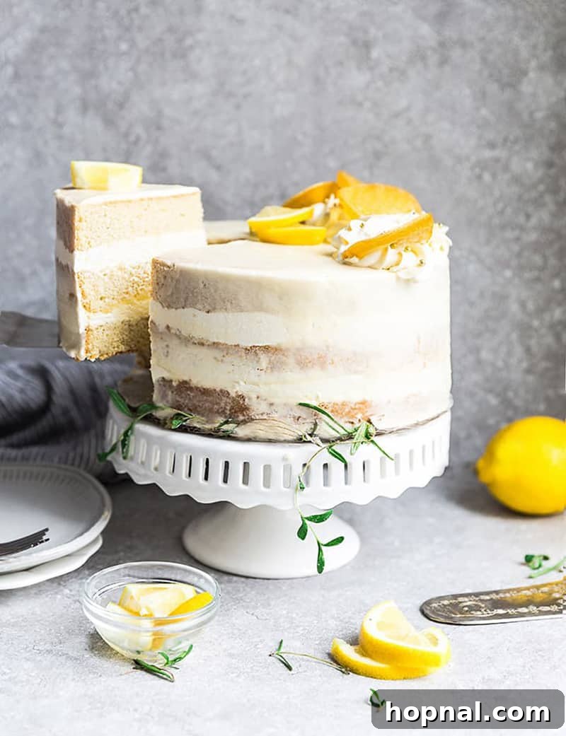 Bright and zesty Keto lemon cake with a slice removed, adorned with fresh lemon wedges, highlighting its refreshing layers.