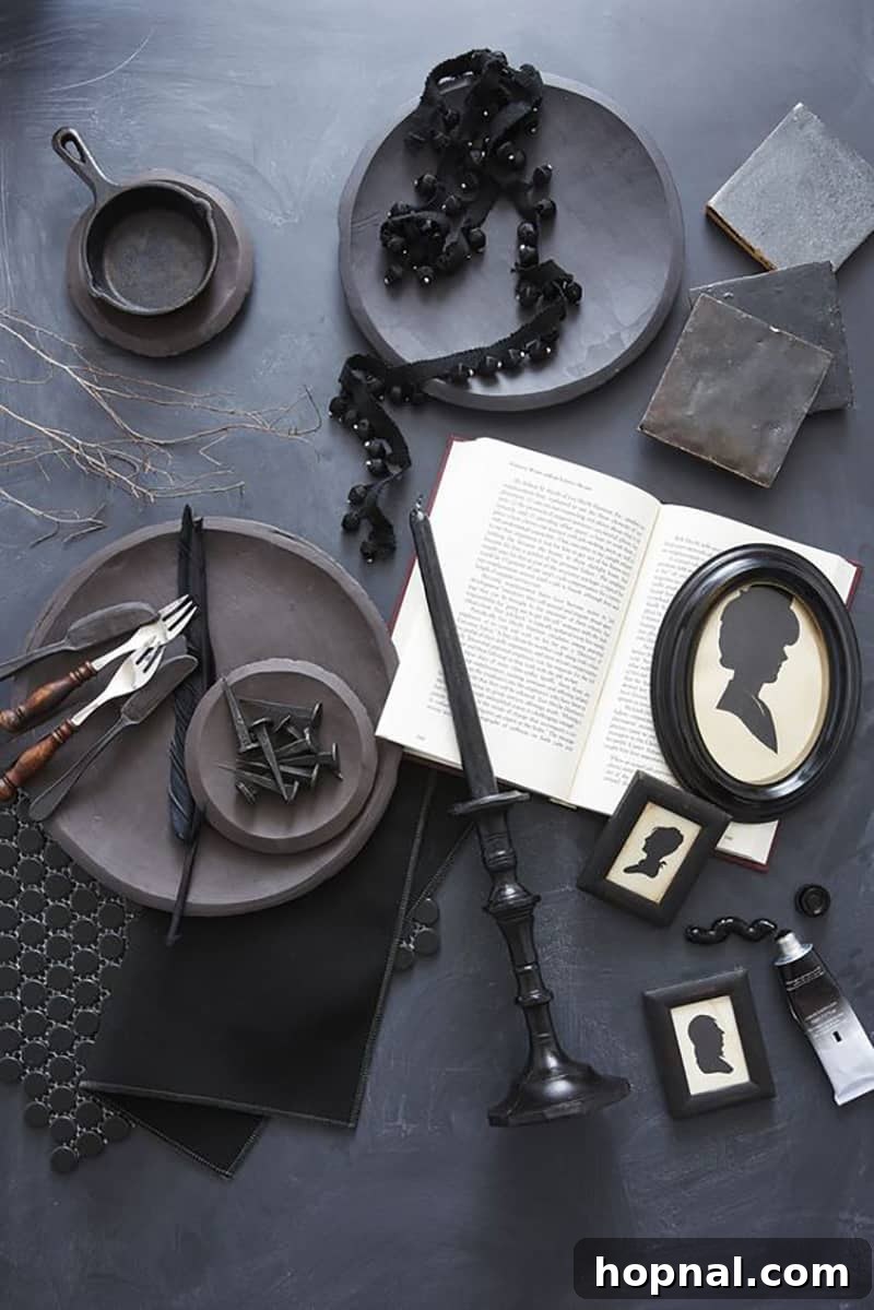 An elegant Halloween party table setting with black plates, dark napkins, and a mysterious book, creating a sophisticated spooky atmosphere.