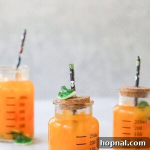 Halloween Punch for Kids served in a jar with gummy worms.