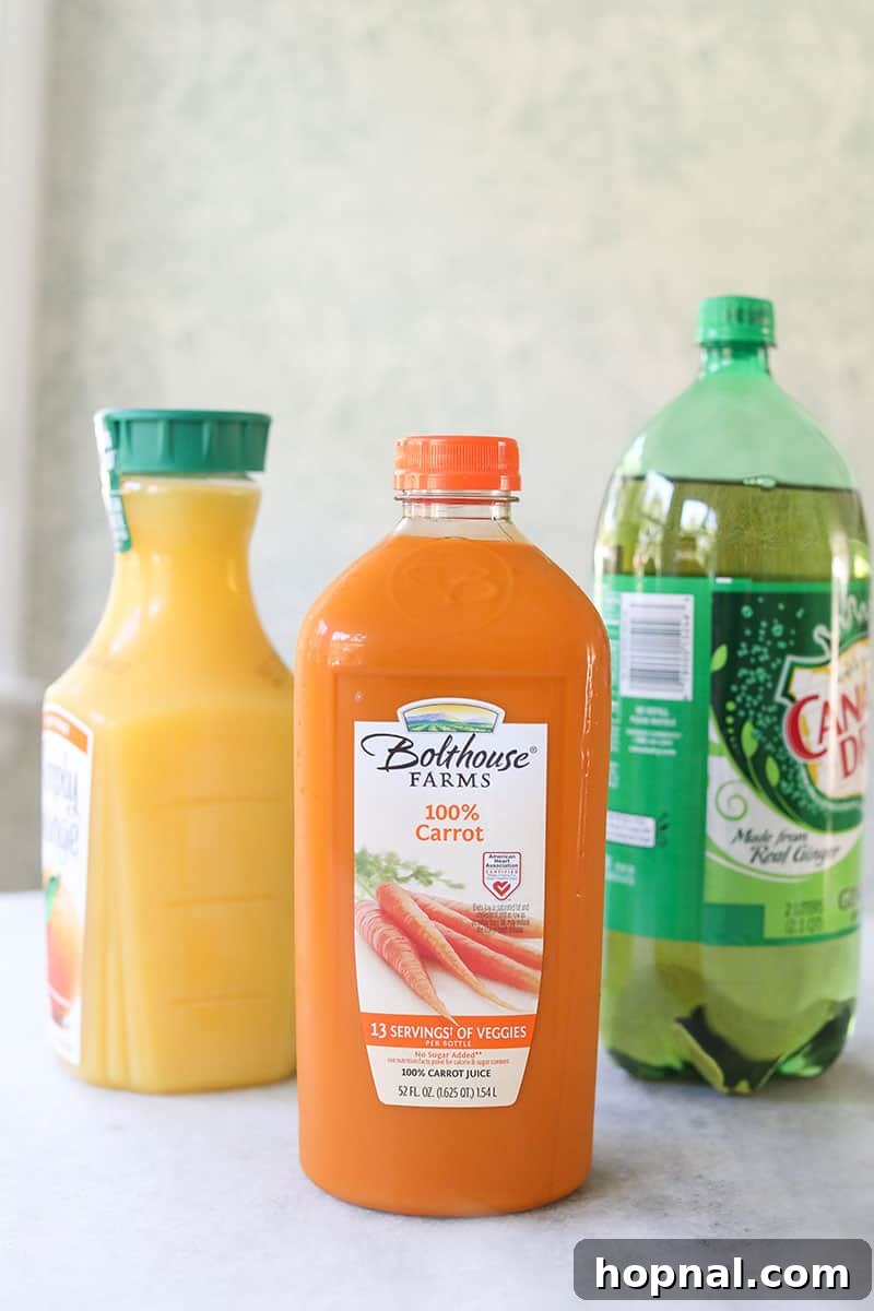 Carrot juice, orange juice and ginger ale bottles on a table.