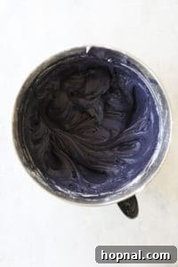 Cream cheese being added to frosting mixture.