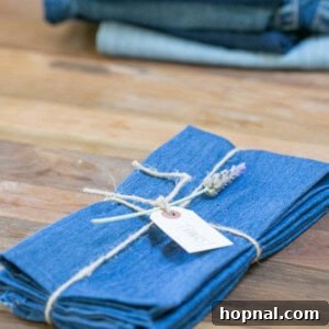 Finished DIY denim napkins, neatly folded and ready for a meal.