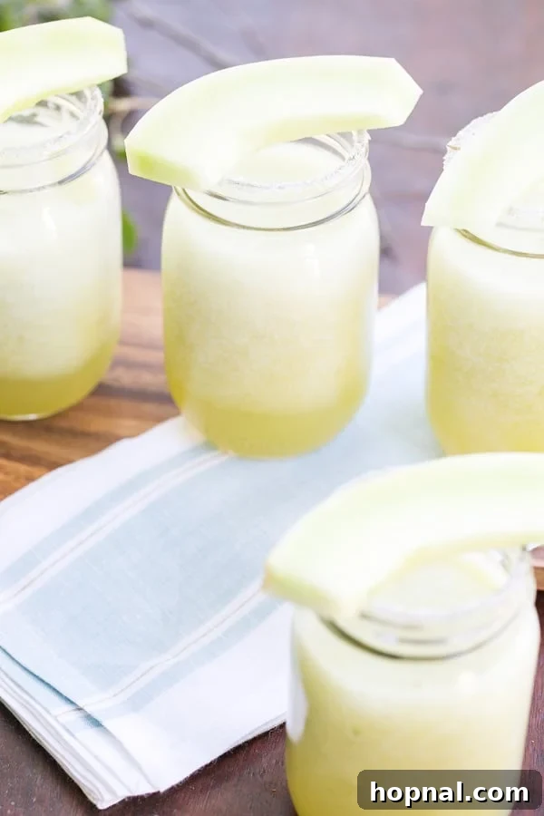 Frozen Cucumber Honeydew Gin Cocktail in a glass, garnished with honeydew slice