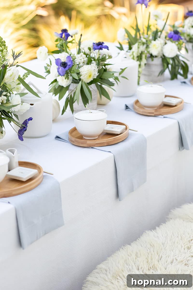 A beautifully arranged tea party table adorned with exquisite tea sets and seasonal flowers, embodying a modern fall theme.