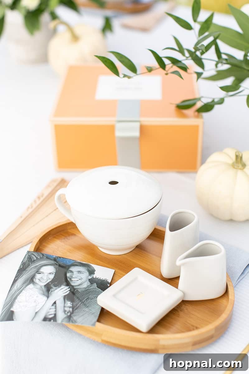 A beautifully arranged bridal shower table, featuring a tea set, personalized photo frame, and delicate decorations, creating a warm and intimate atmosphere.