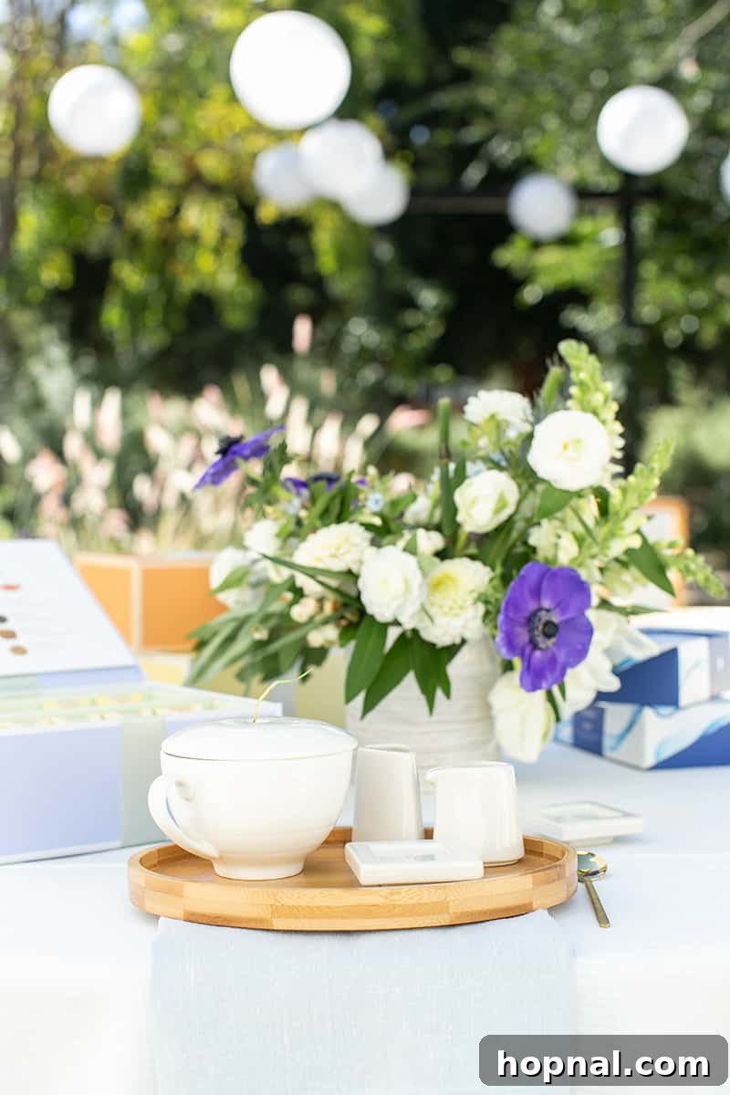 Exquisite tea set with fine china and a vibrant floral arrangement, ready for an elegant bridal shower tea party.