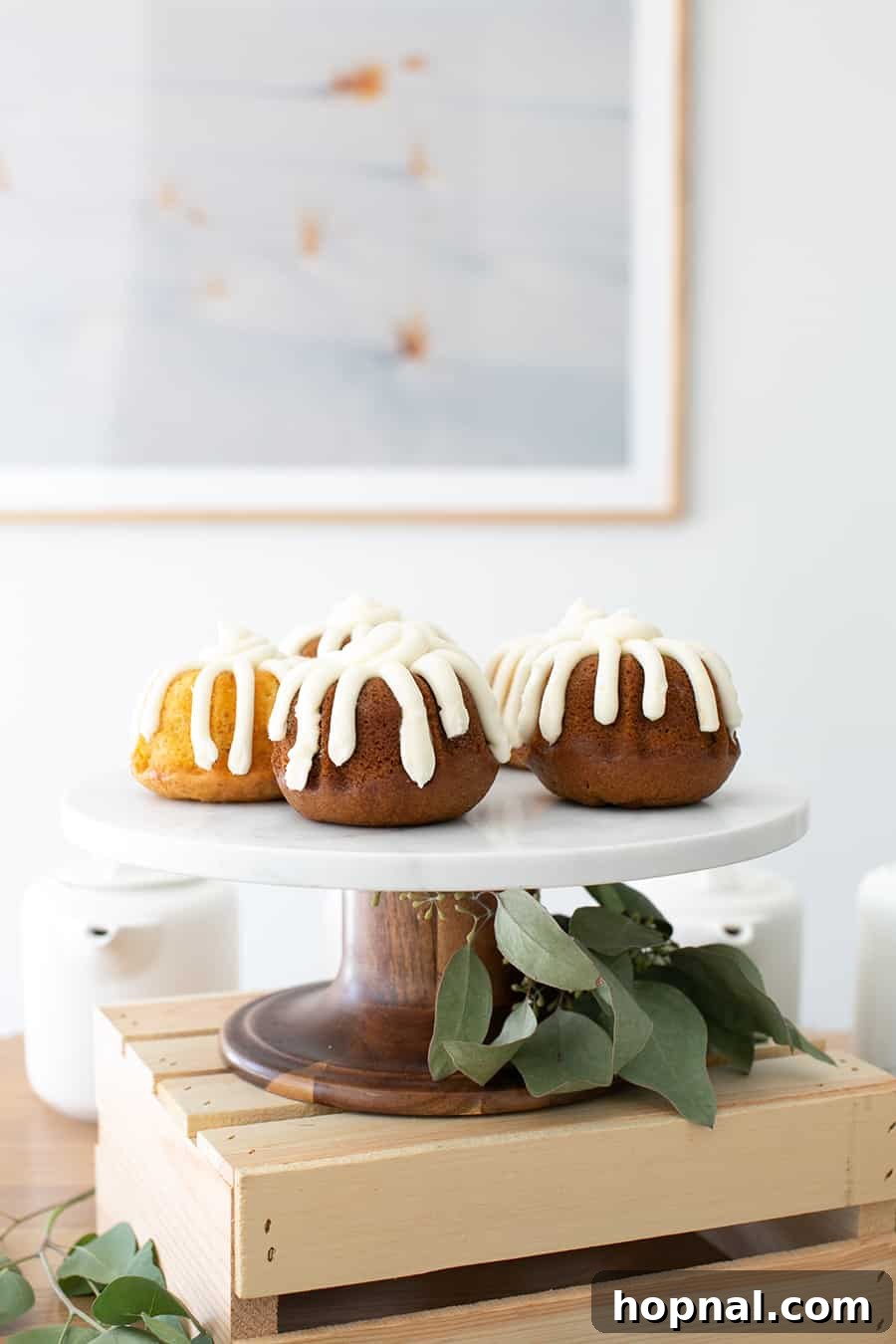 A delectable display of mini bundt cakes, beautifully arranged on a tiered cake stand, ready to be enjoyed as tea party desserts.