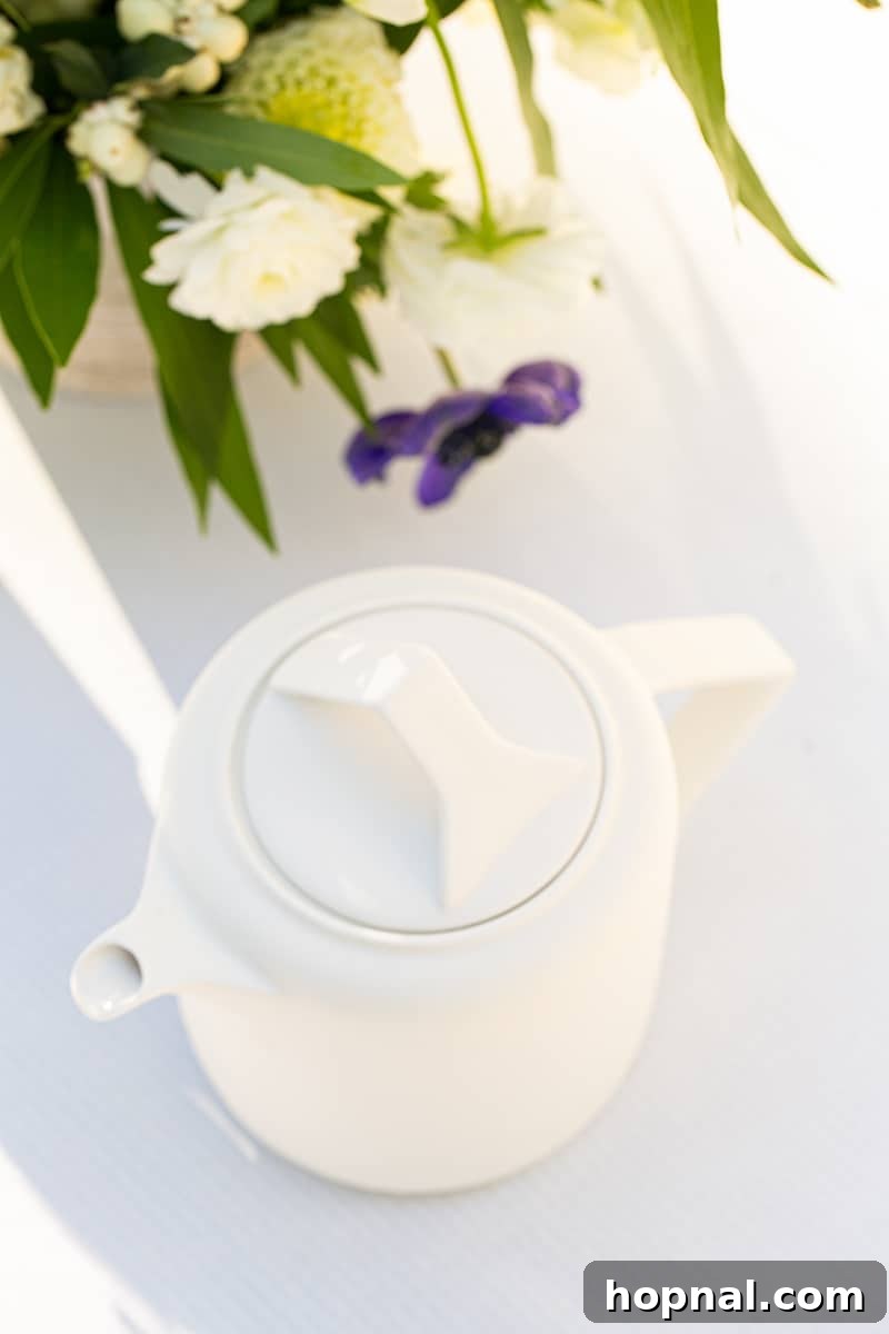A minimalist white modern tea kettle, elegantly designed, hinting at effortless tea preparation.