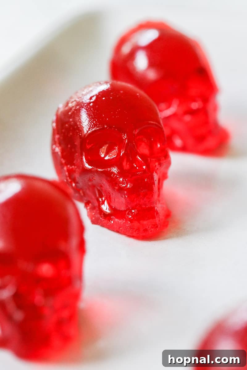 A mesmerizing collection of perfectly formed red jello shot skulls, ready for a Halloween gathering.