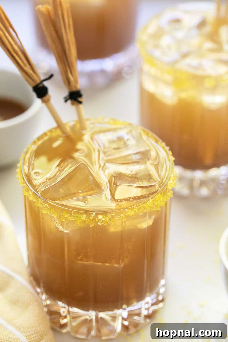 Homemade butterbeer, a magical Harry Potter-themed drink idea for a kids' Halloween party, served in classic mugs.