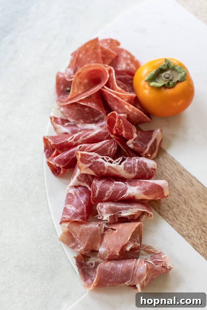 Rolled up charcuterie to make a Thanksgiving appetizer board.