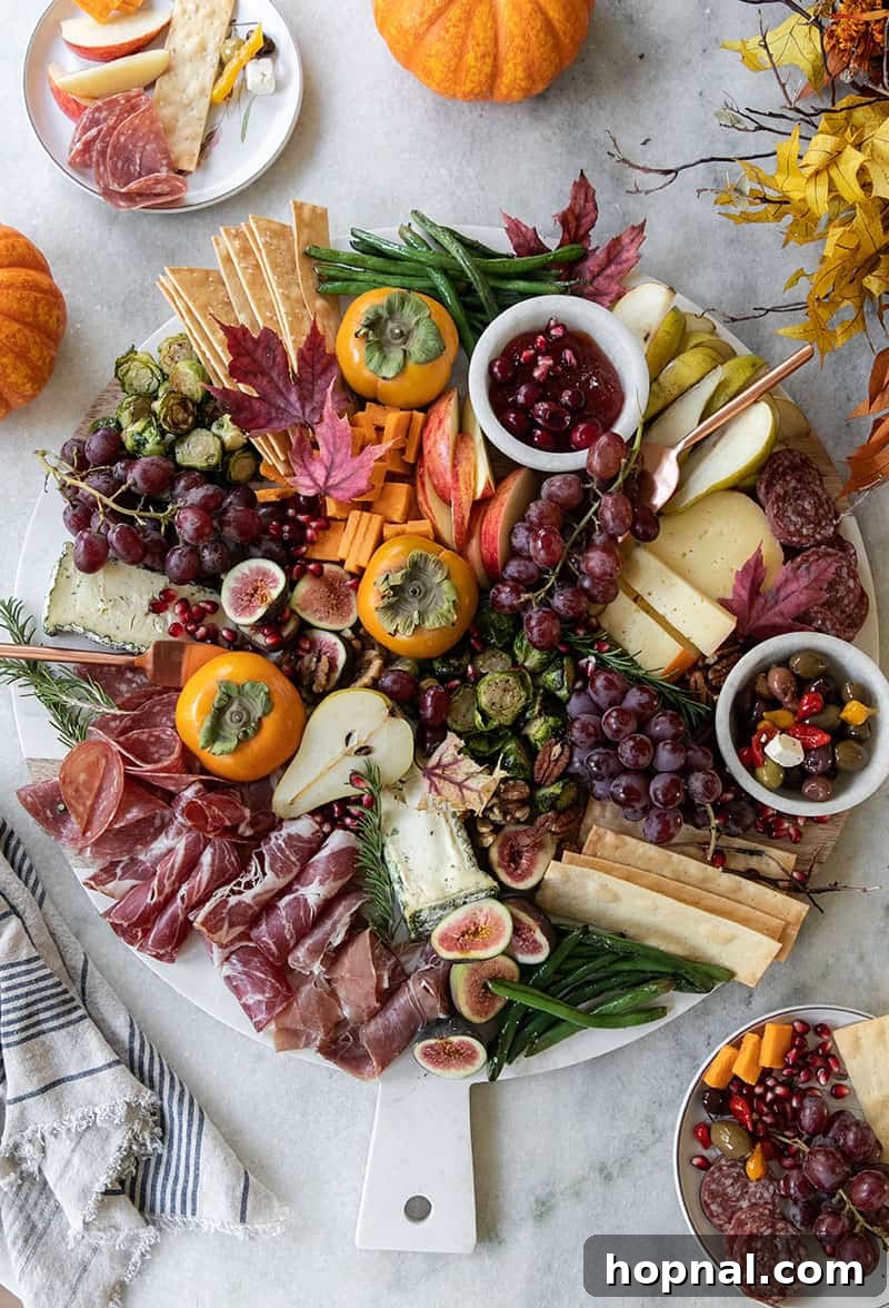 Best Thanksgiving appetizer recipe with cheese, meat and crackers on a giant marble board.