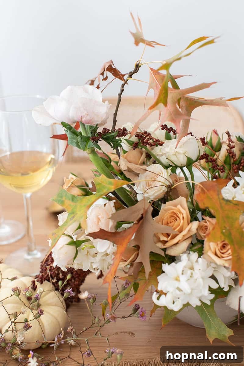 A vibrant fall flower arrangement, showcasing seasonal blooms and foliage, perfect as a centerpiece for a Thanksgiving table.