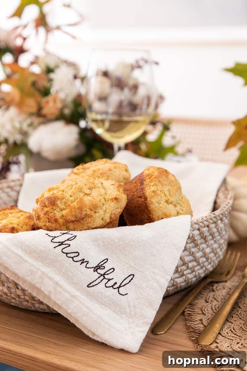 Warm cornbread muffins, freshly baked and nestled in a rustic basket, ready to be served with Thanksgiving dinner.