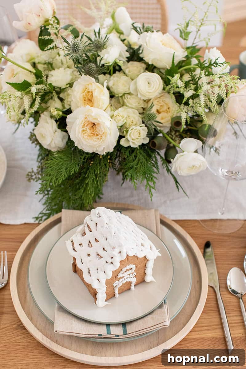 A graceful white and green flower arrangement, perfect for a Christmas Eve Dinner centerpiece.