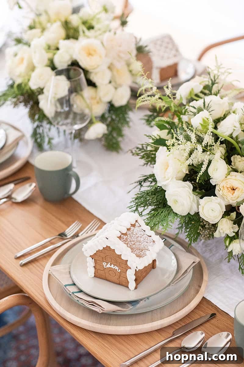 A charming gingerbread house, used as a name place card, on a festive Christmas table.