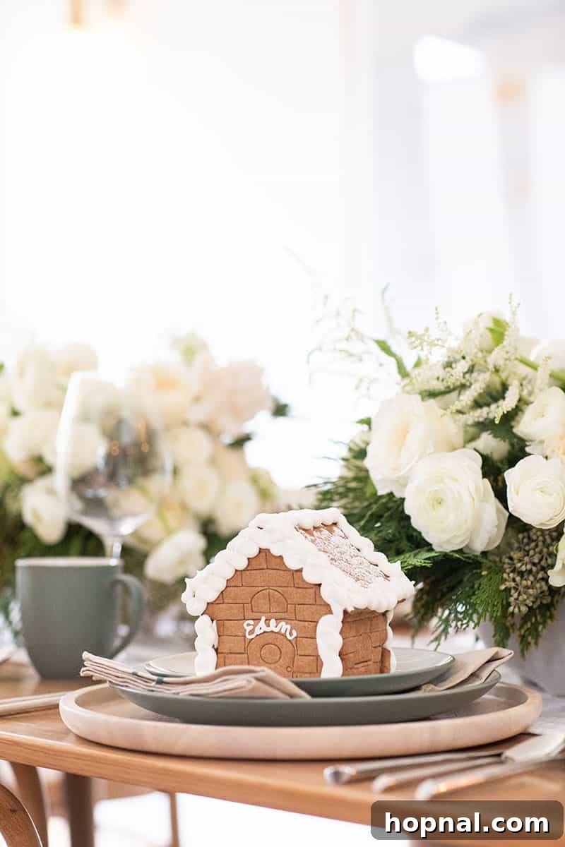 A charming gingerbread house with the name 'Eden' elegantly piped in frosting, serving as a unique place card.