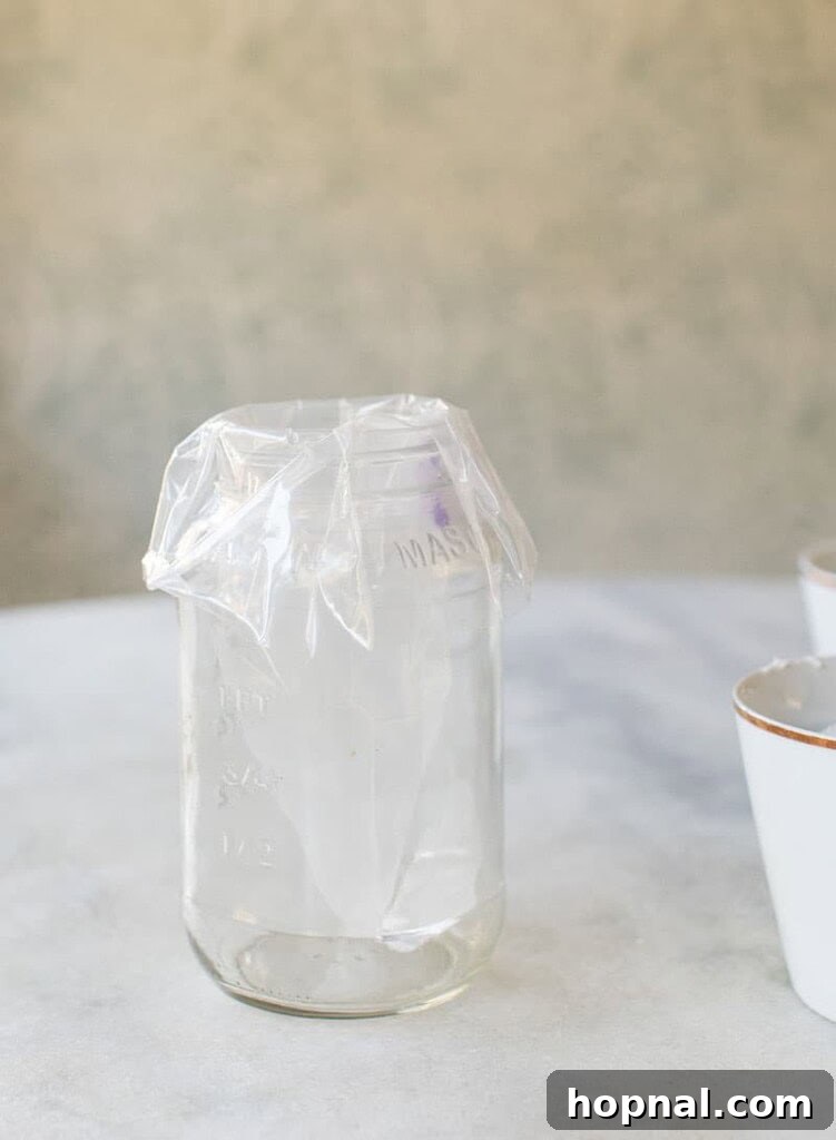 An ingenious tip for filling a piping bag: placing it in an empty jar with edges folded over.