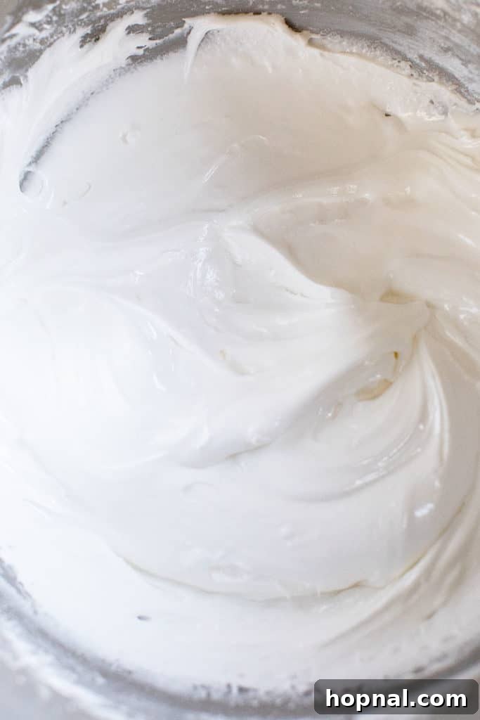 A bowl filled with freshly made, fluffy gingerbread house icing, ready for decorating.