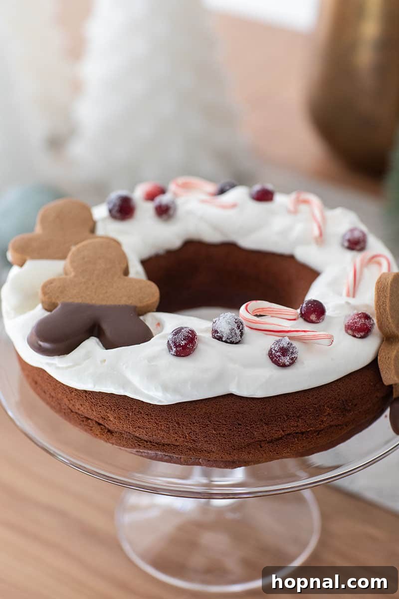 The Ultimate Guide to a Showstopping Christmas Dessert Display 12 A festive gingerbread bundt cake adorned with gingerbread men, fresh berries, and candy canes, ready for holiday celebrations.