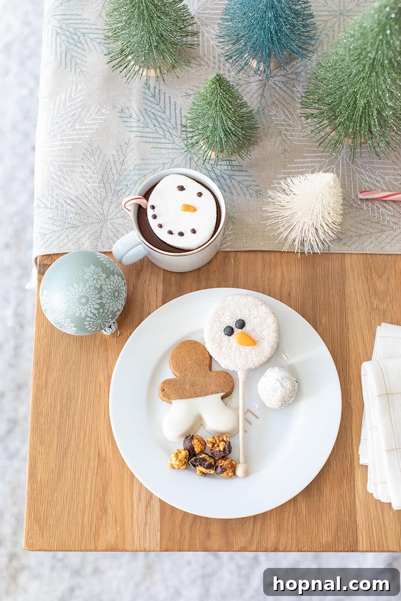 The Ultimate Guide to a Showstopping Christmas Dessert Display 14 Holiday desserts presented on a gold and white plate, featuring a snowman cake pop and a gingerbread cookie for a festive touch.