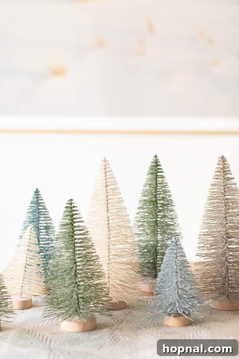 The Ultimate Guide to a Showstopping Christmas Dessert Display 7 A charming collection of blue, green, and white bottle brush Christmas trees arranged on a table, adding a festive touch.