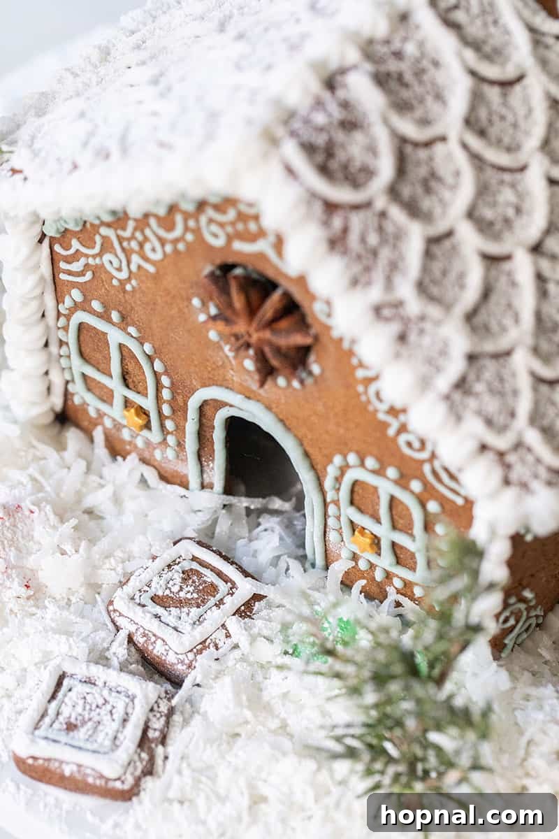 A beautifully decorated gingerbread house covered in fluffy coconut snow, creating a charming winter scene that looks almost magical.
