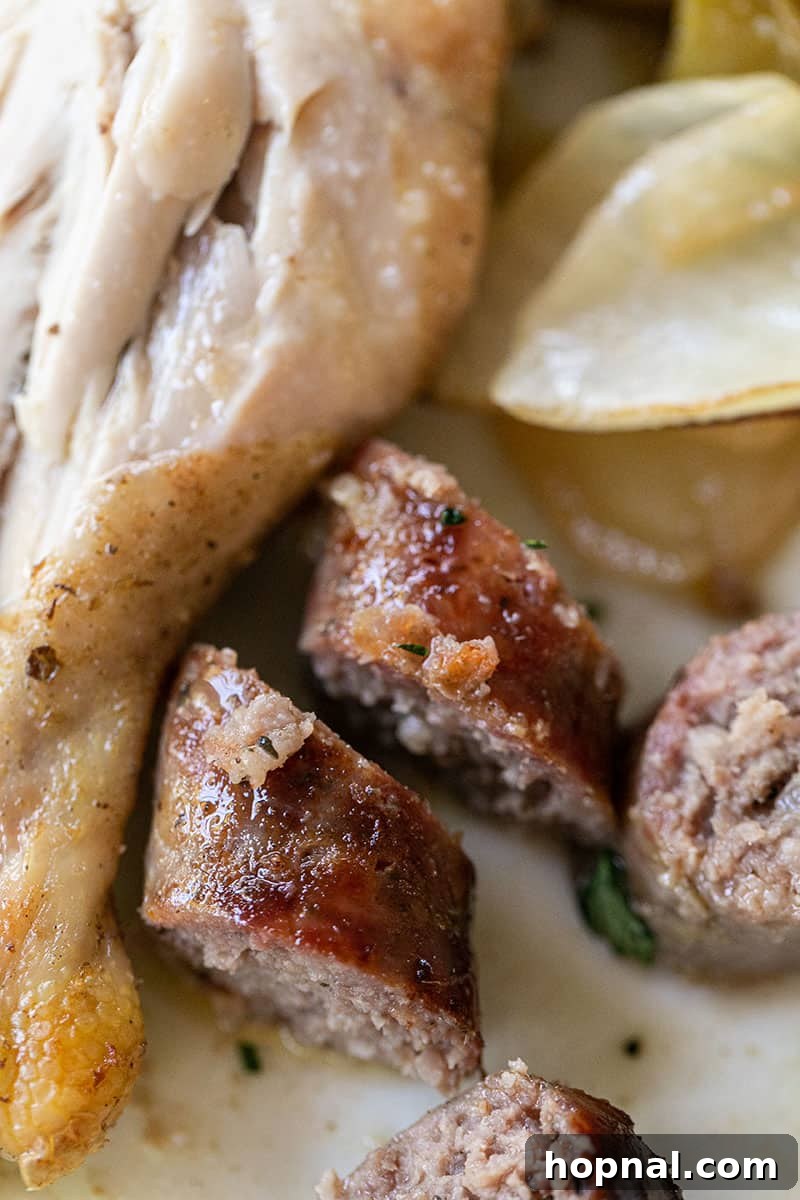 Sausage links cut alongside baked chicken pieces, ready for serving.