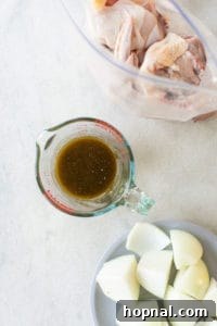 Close-up of a small bowl containing olive oil, Worcestershire sauce, and spices for the marinade.